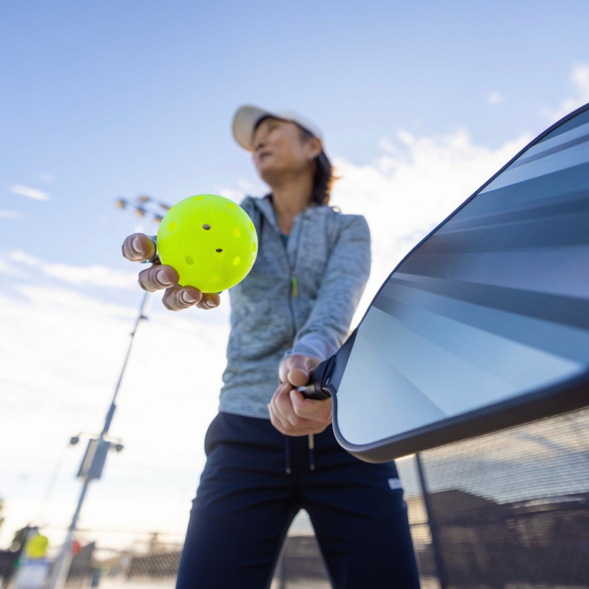 woman about to serve pickleball